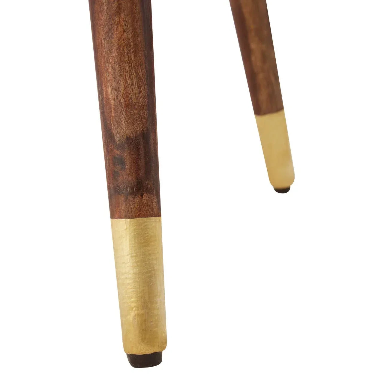 Wooden furniture legs with gold metal caps close-up