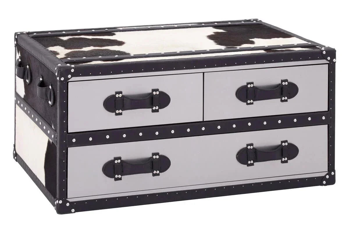 Cowhide effect storage trunk coffee table with four drawers, studded trim and leather handles