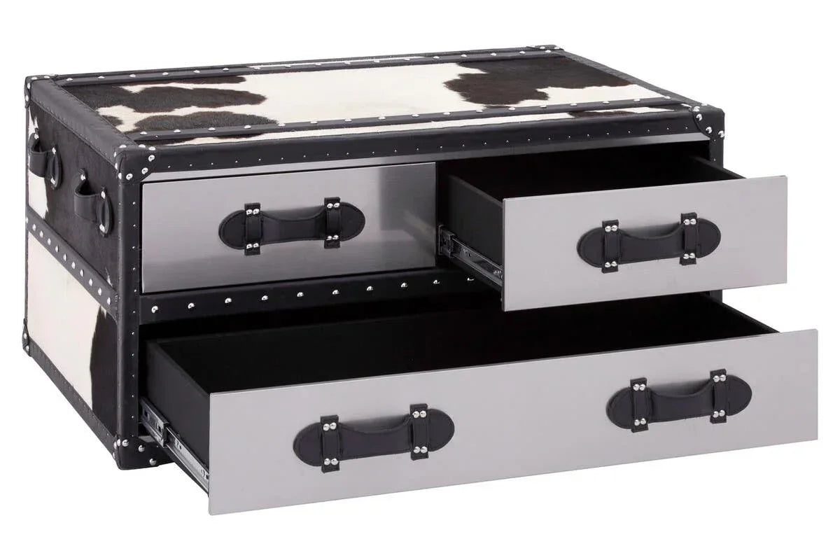 Cowhide trunk coffee table with two open drawers and metal handles