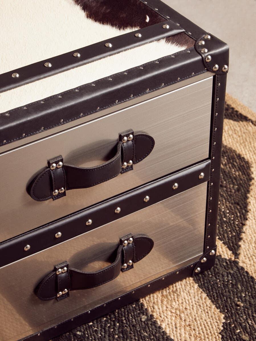 Metal and leather storage chest with two drawers, stud detailing, and cowhide top