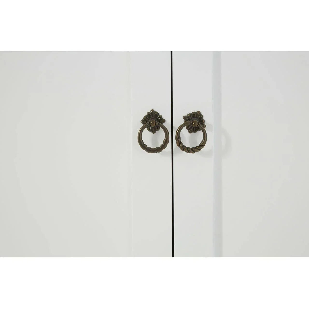 White cabinet doors with antique brass ring handles close-up