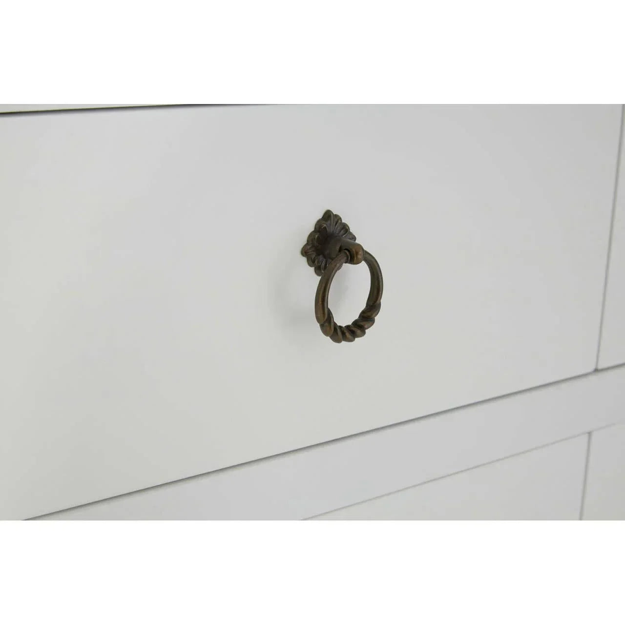 White wooden drawer with antique brass ring handle close up