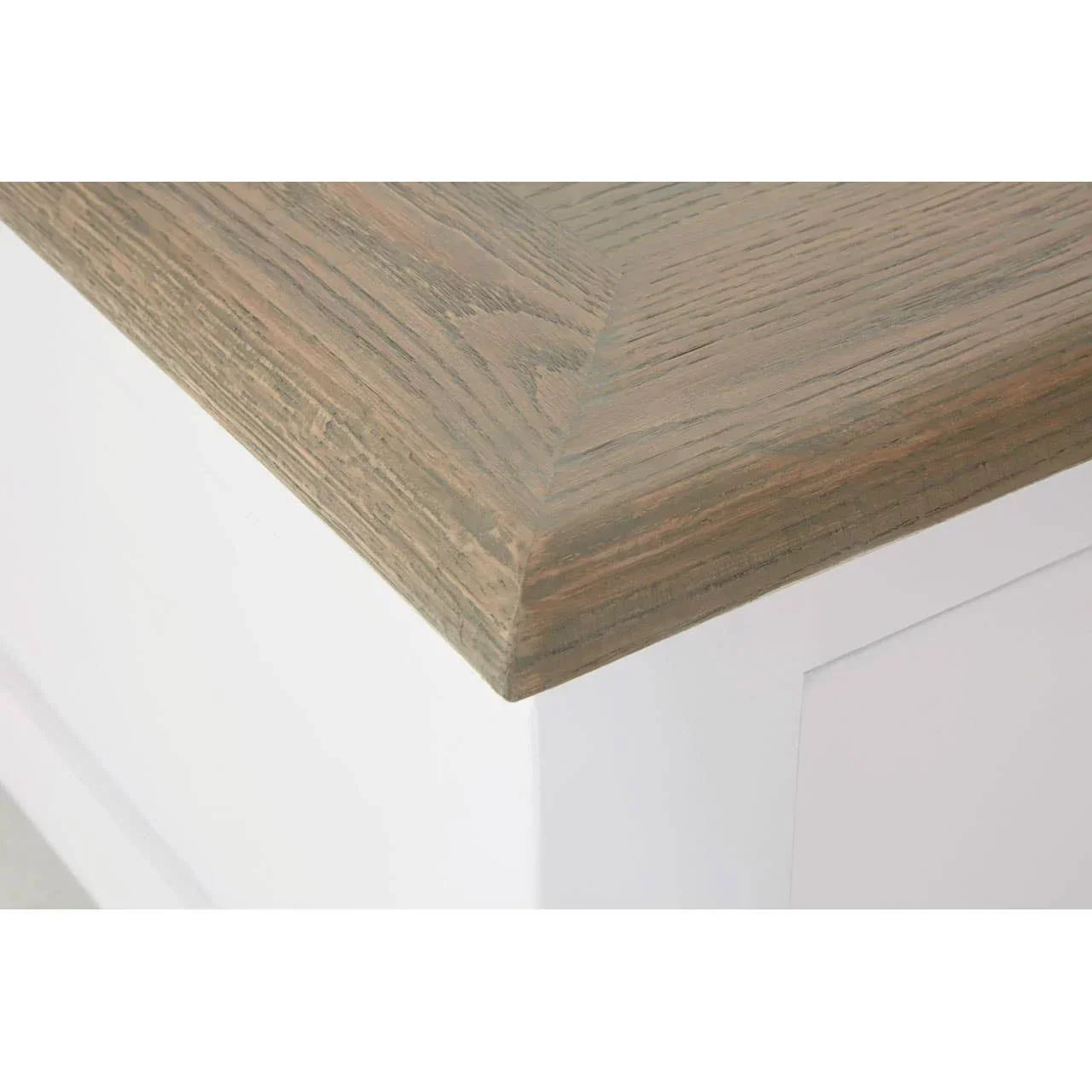 Close-up of wooden dining table corner with white painted base and natural oak top