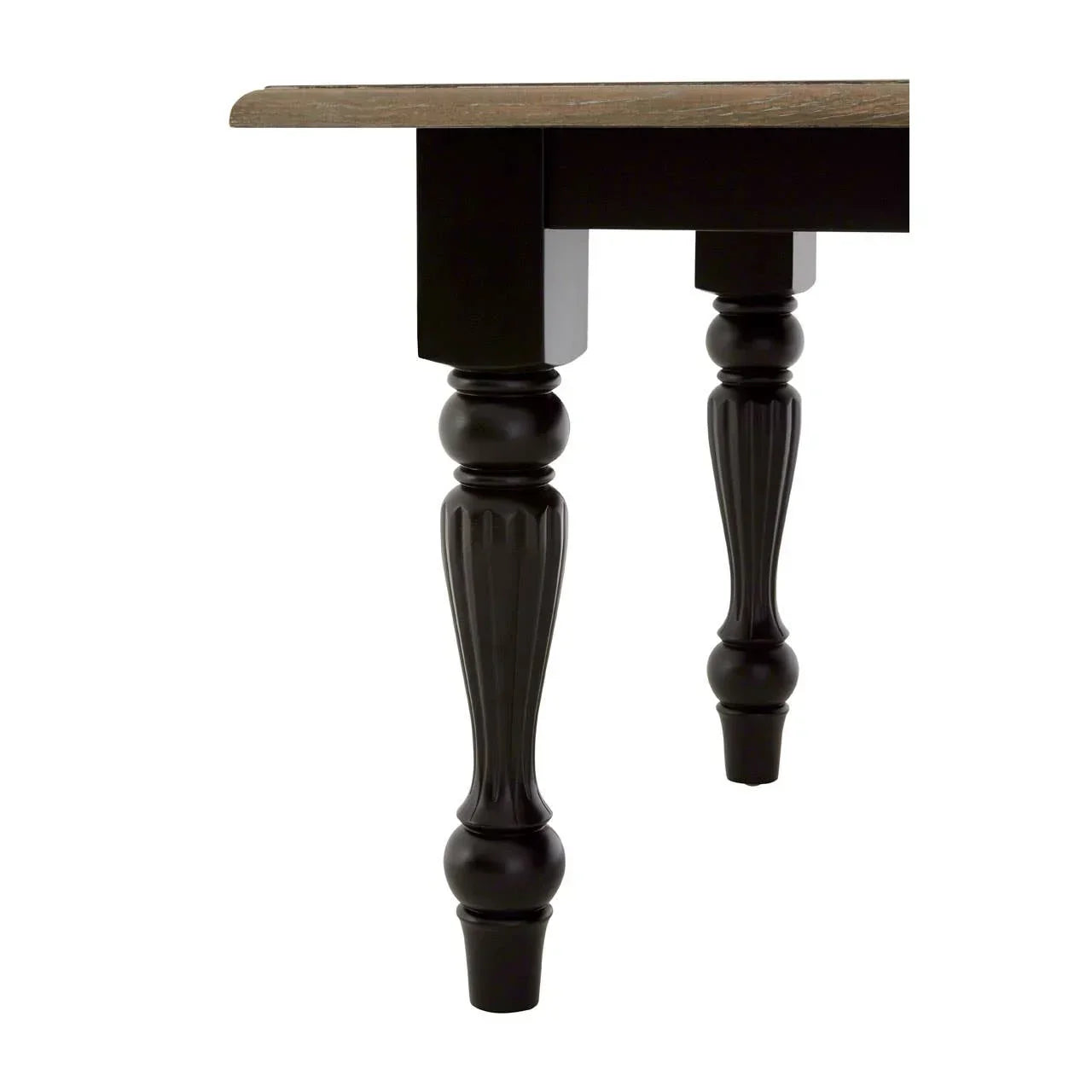 Wood dining table with black turned legs and oak effect top, angled side view