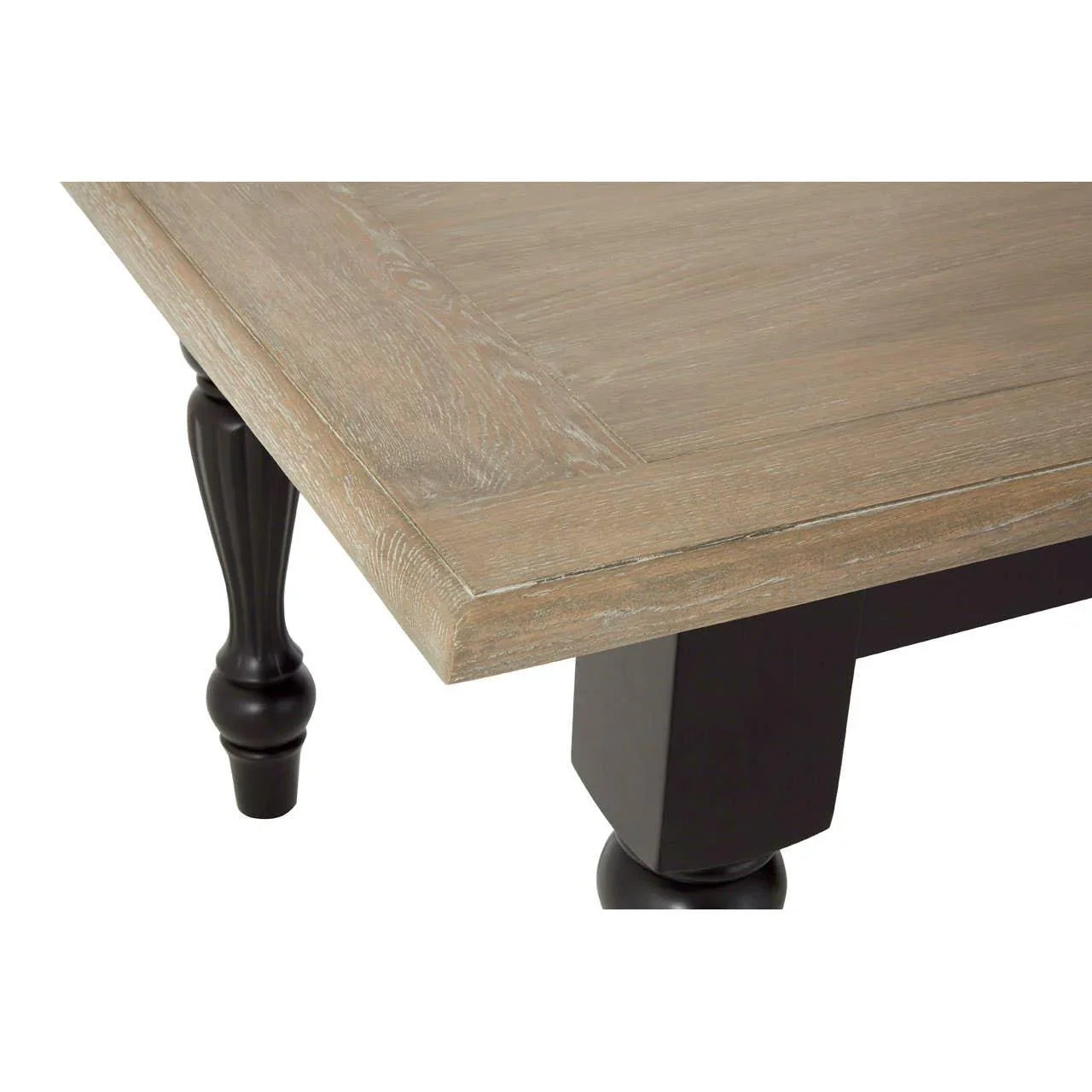 Wood dining table corner detail with black turned leg and light oak finish top