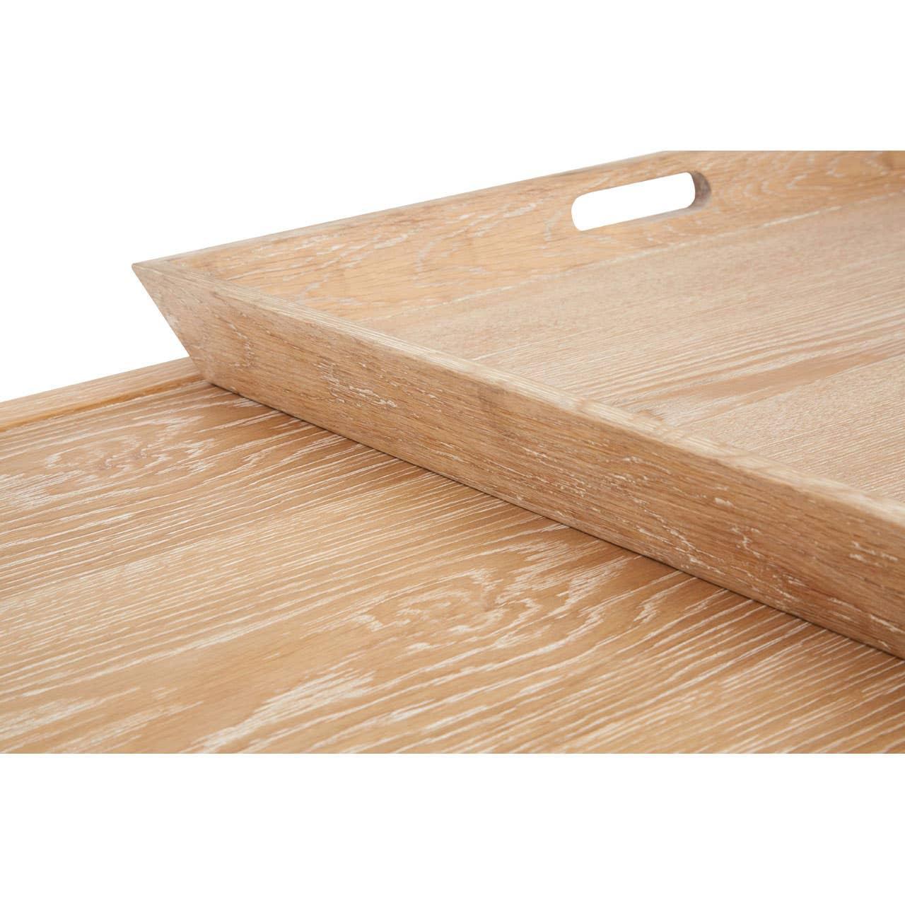 Oak serving tray with cutout handles on matching wood grain surface, close up view