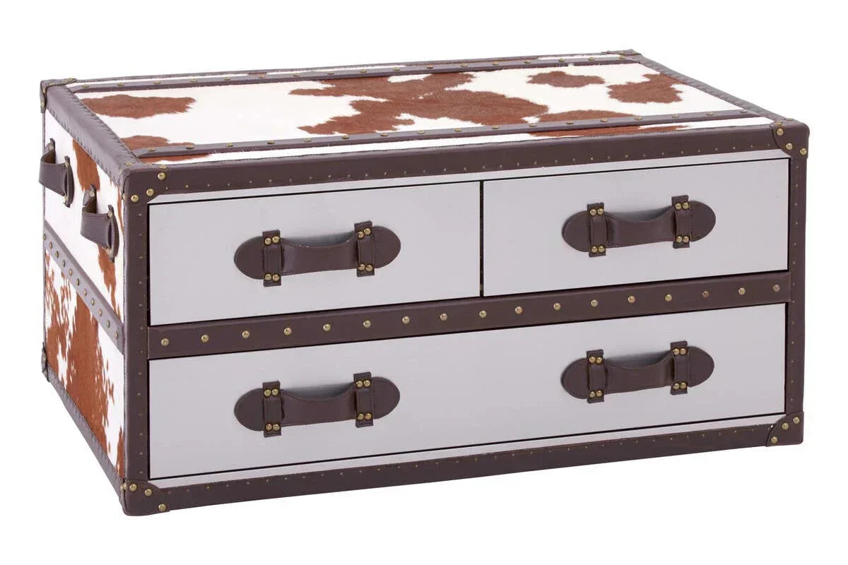 Cowhide trunk coffee table with brown leather handles and metal stud detail