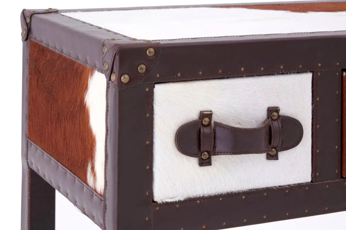 Closeup of cowhide and leather drawer on brown and white storage trunk table