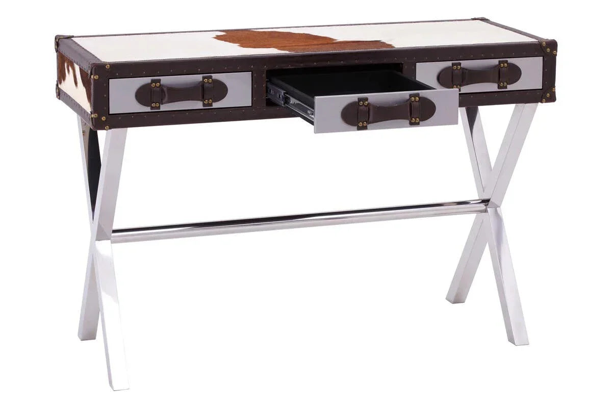 Contemporary writing desk with chrome legs, cowhide top, and three front drawers, one open