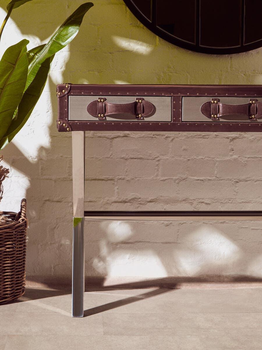 Brown and silver hallway console table with metal legs and suitcase-style drawers