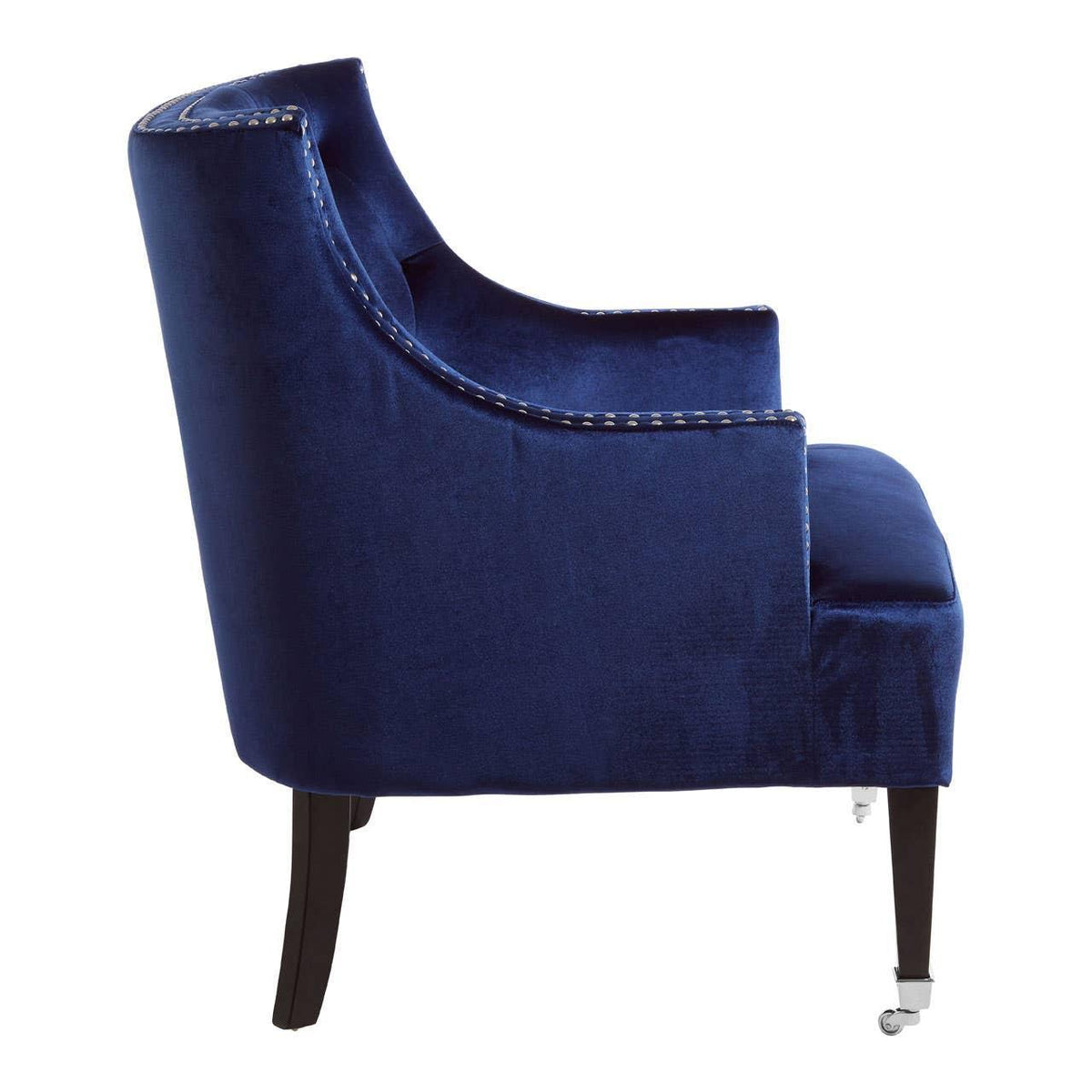 Side view of blue velvet armchair with dark wooden legs and silver castor wheels