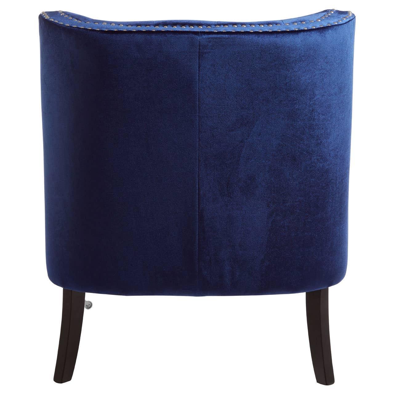 Rear view of blue velvet accent chair with dark wood legs and silver nailhead trim