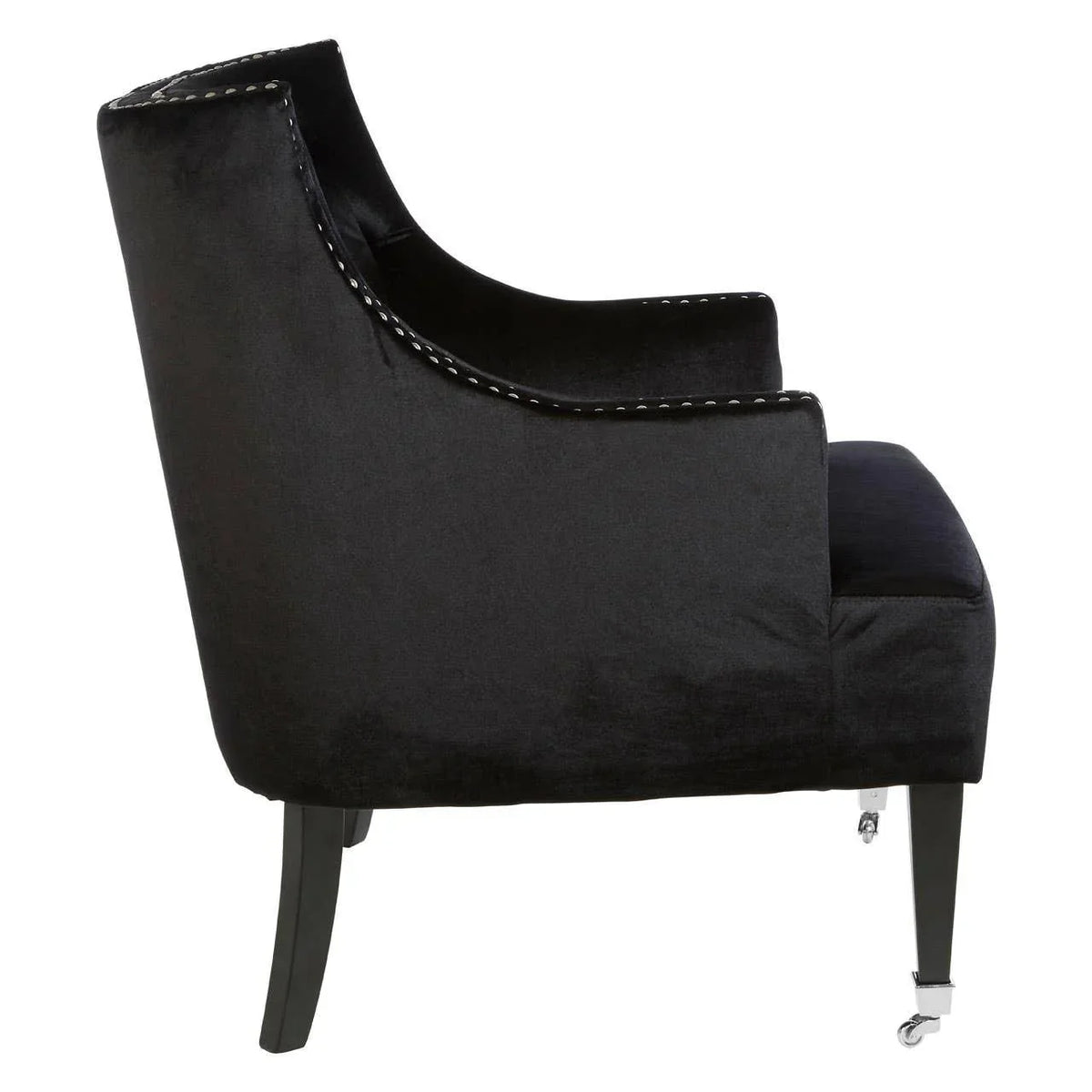 Black velvet accent chair with silver stud trim and front leg casters, side profile view