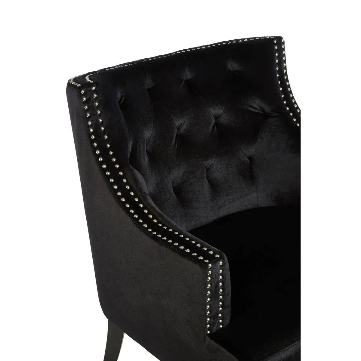 Black velvet accent chair with button tufted back and silver studded trim detail