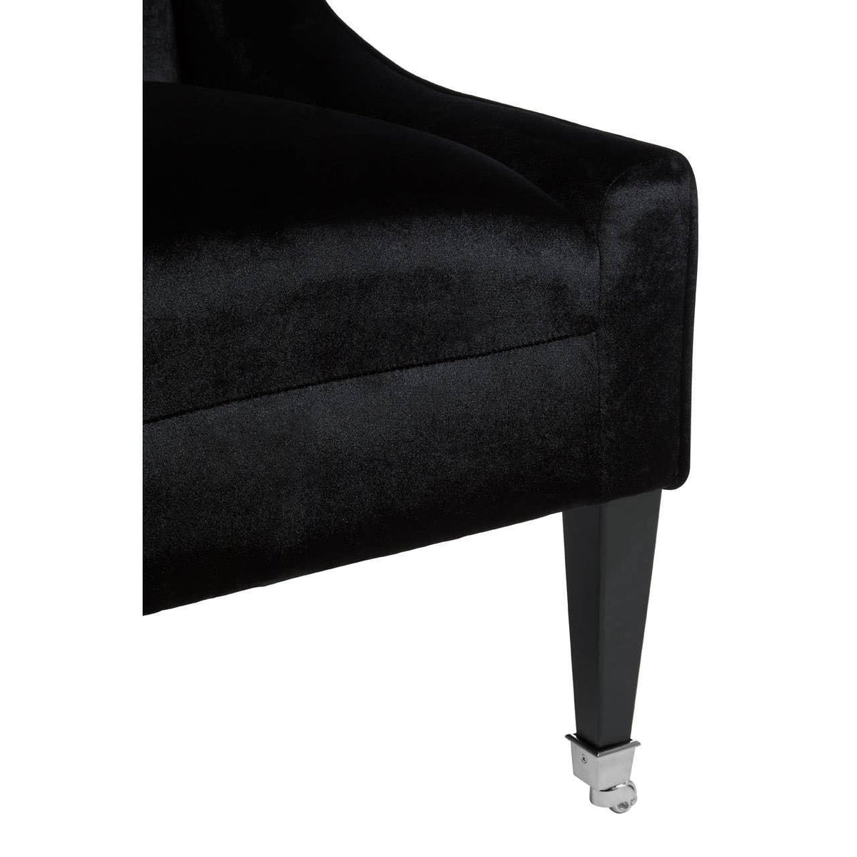 Black velvet chair corner with angular armrest and chrome castor leg detail