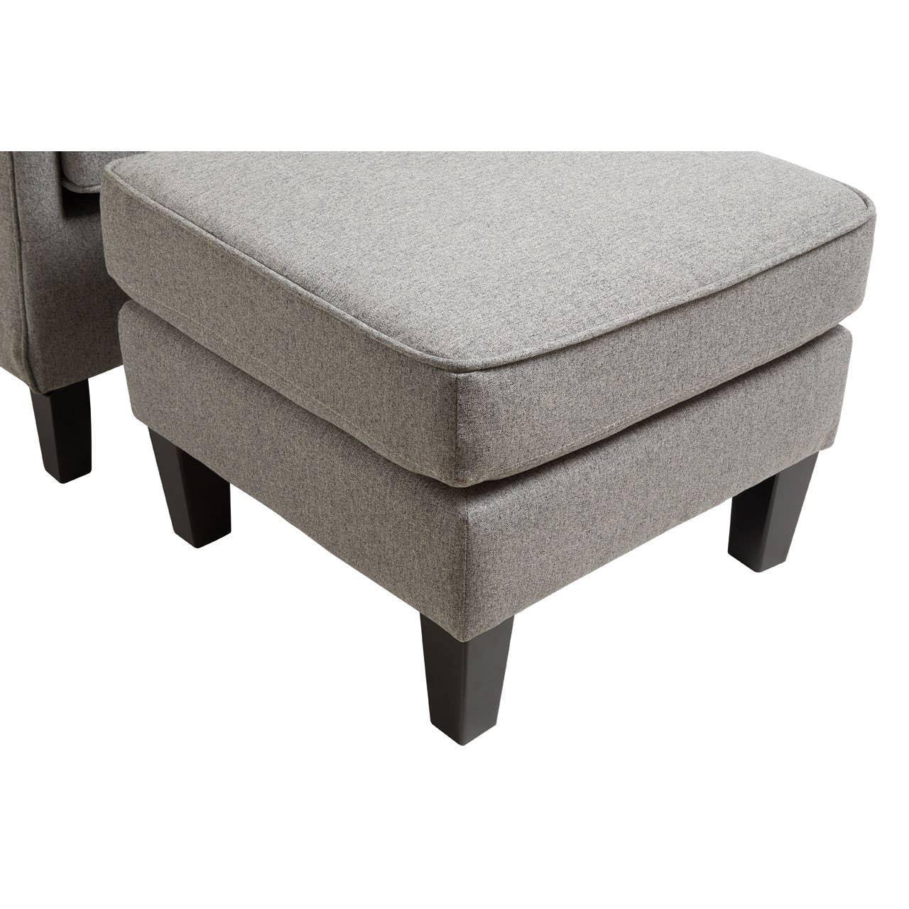 Grey fabric ottoman footstool with black wooden legs, close-up corner view