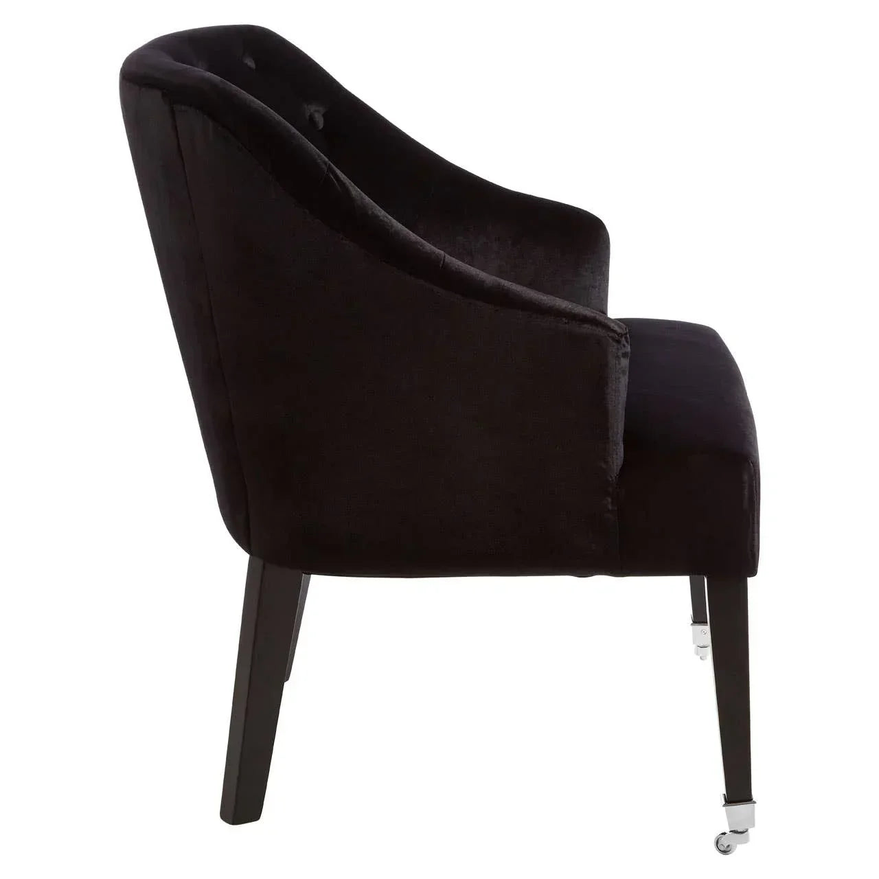 black velvet dining chair with curved backrest and front casters, side profile view