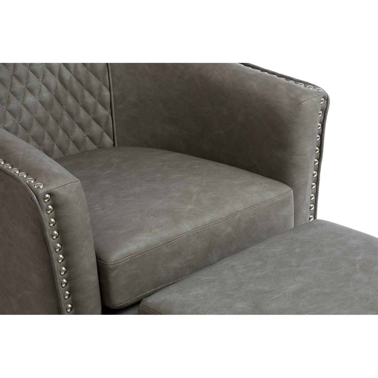Grey armchair with quilted backrest, stud detail, and matching footstool