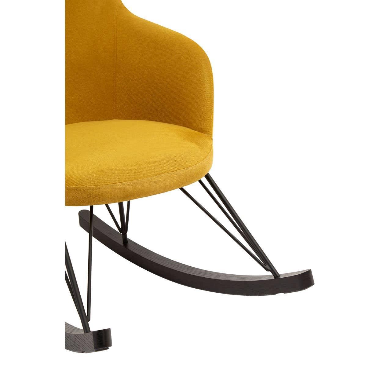 Mustard fabric rocking chair with curved wooden legs and black metal supports, close up view