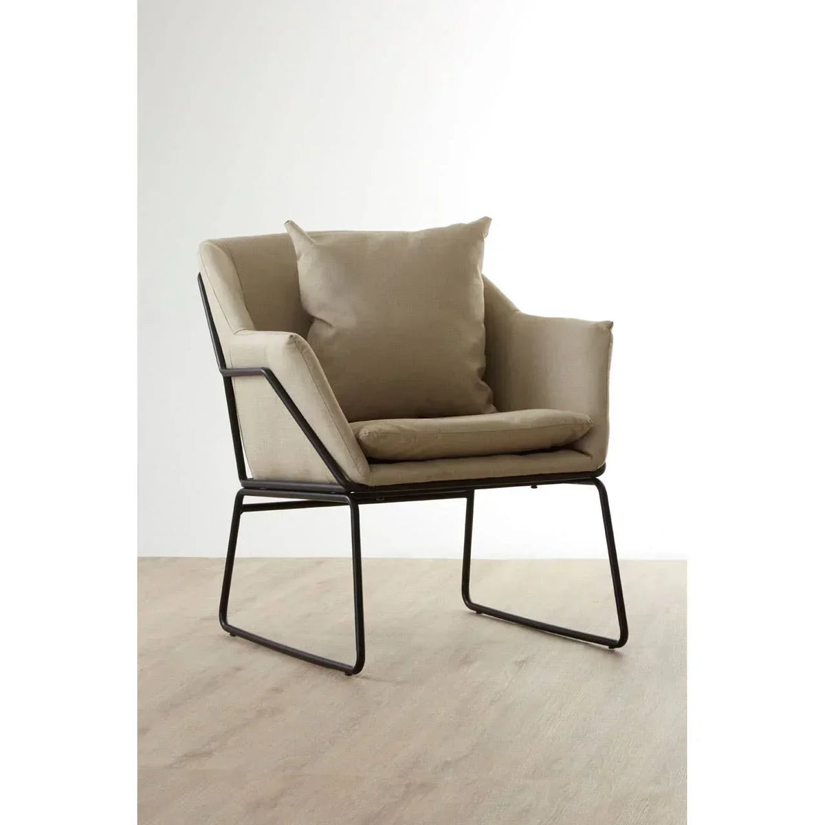 Beige accent armchair with metal frame and cushions on light wooden floor