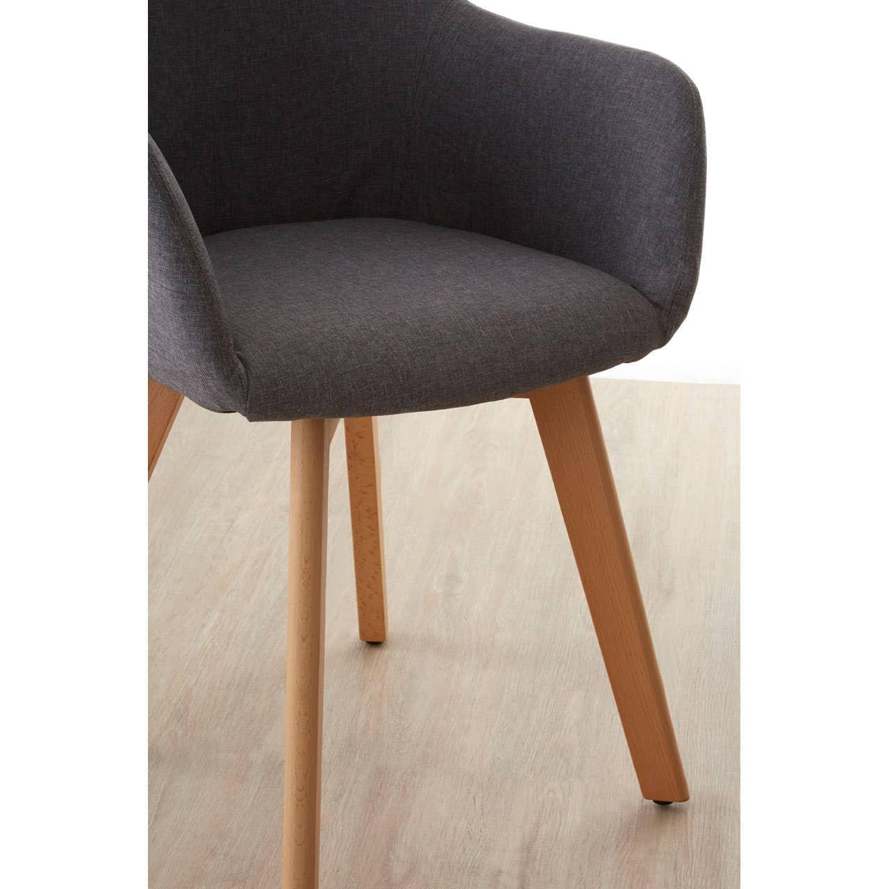 Dark grey fabric dining chair with curved back and wooden legs on light wood floor