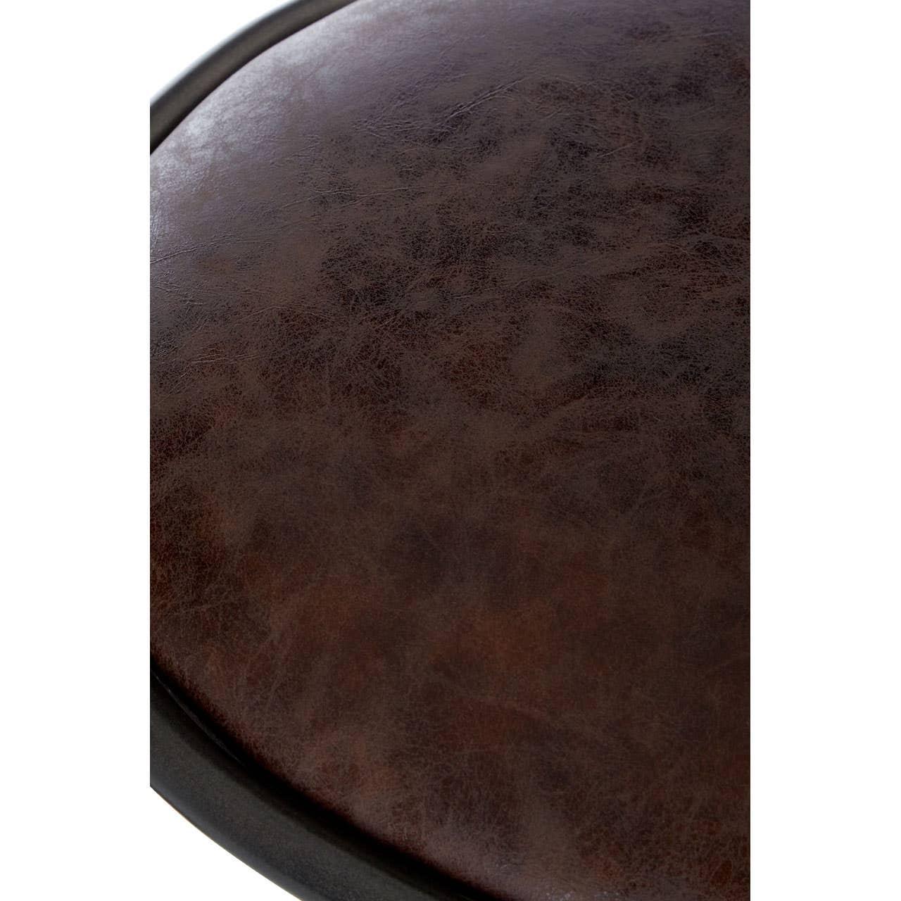 Close-up of round brown leather seat cushion highlighting texture and stitching detail