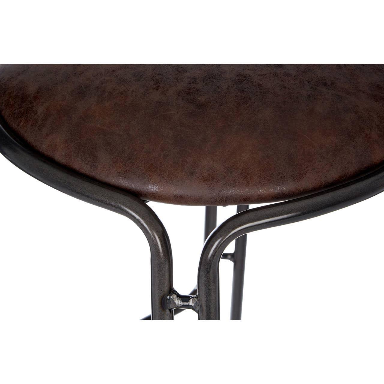 Close-up of brown leather bar stool seat with black metal frame detail