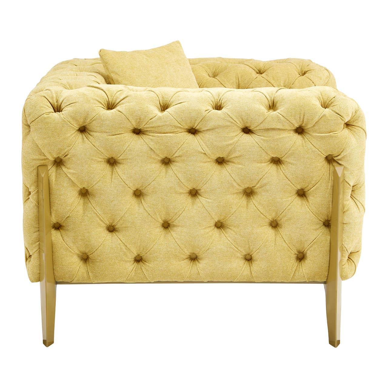 Yellow tufted armchair with gold legs and matching cushion, rear view
