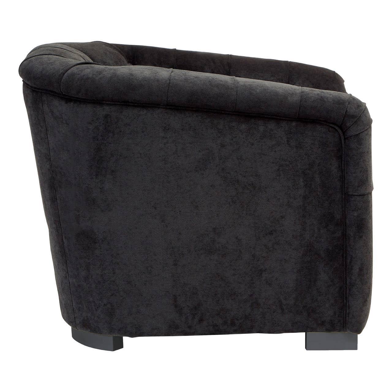 Side view of dark grey fabric armchair with low back and short block feet