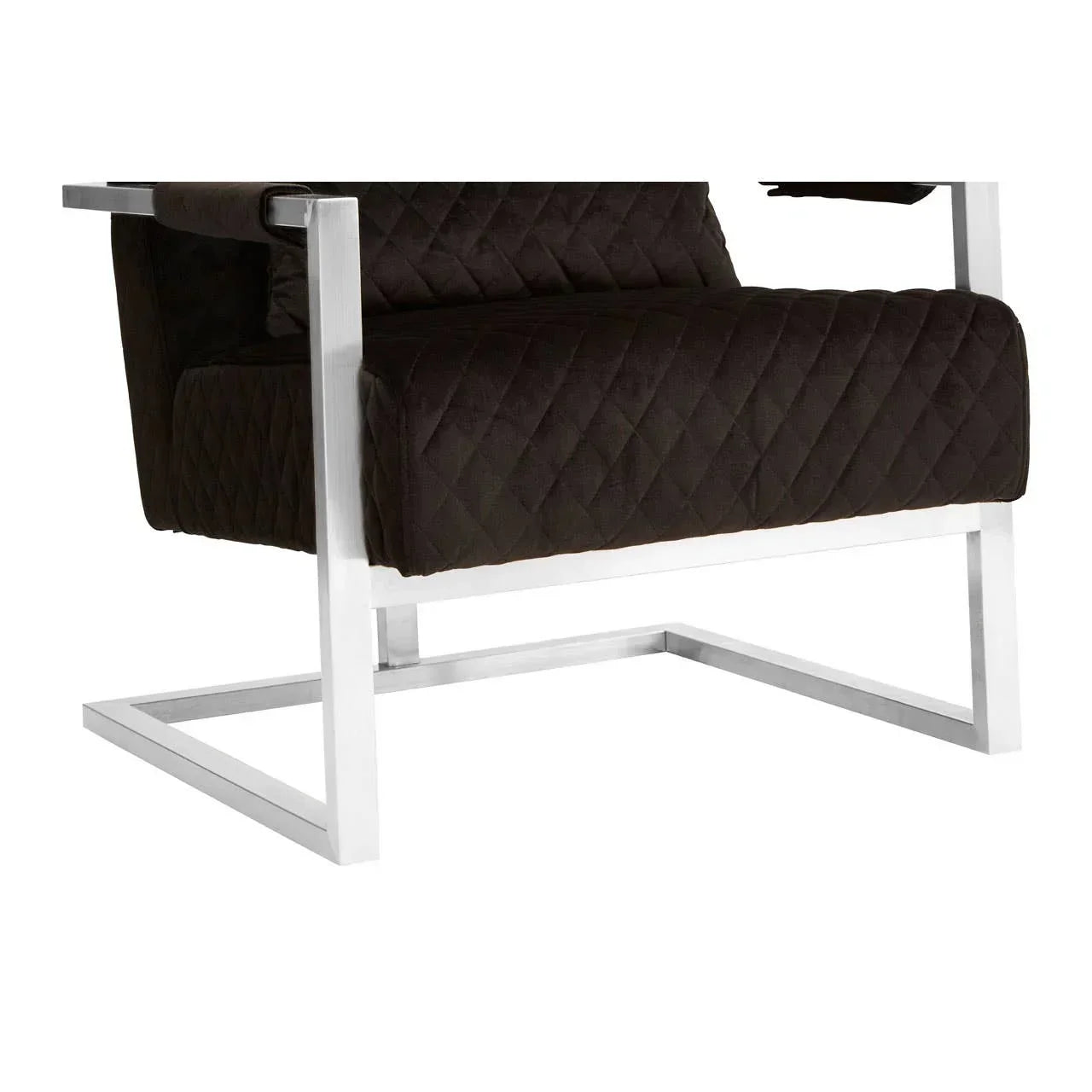 Black velvet accent chair with quilted seat and chrome frame, partial side angle
