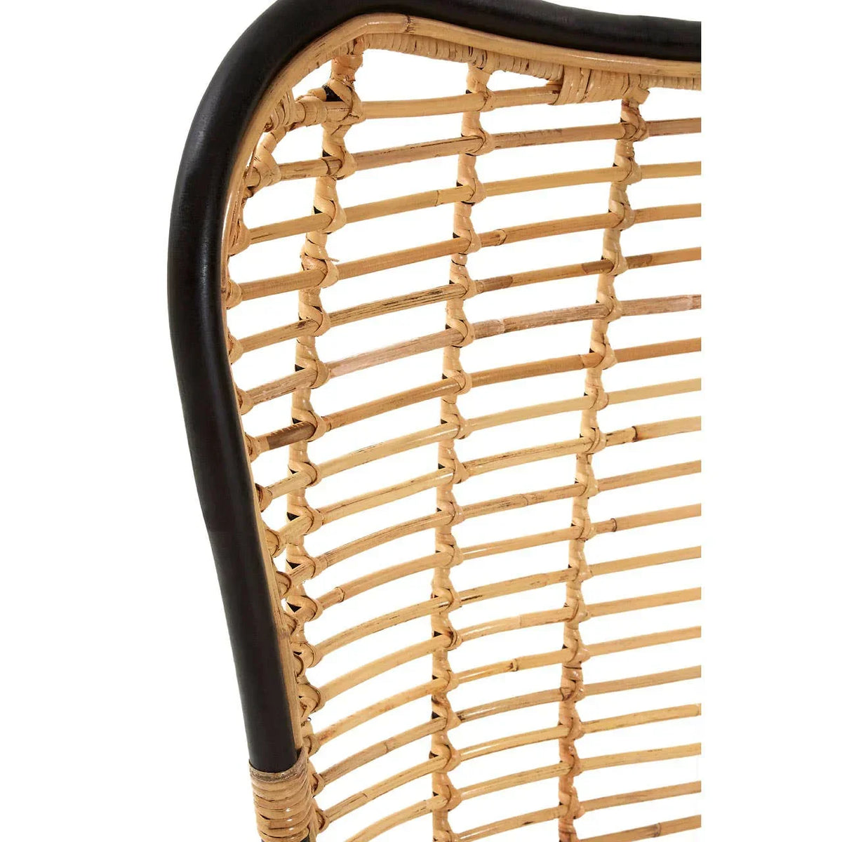 Closeup of rattan chair back with black frame and woven natural cane detail