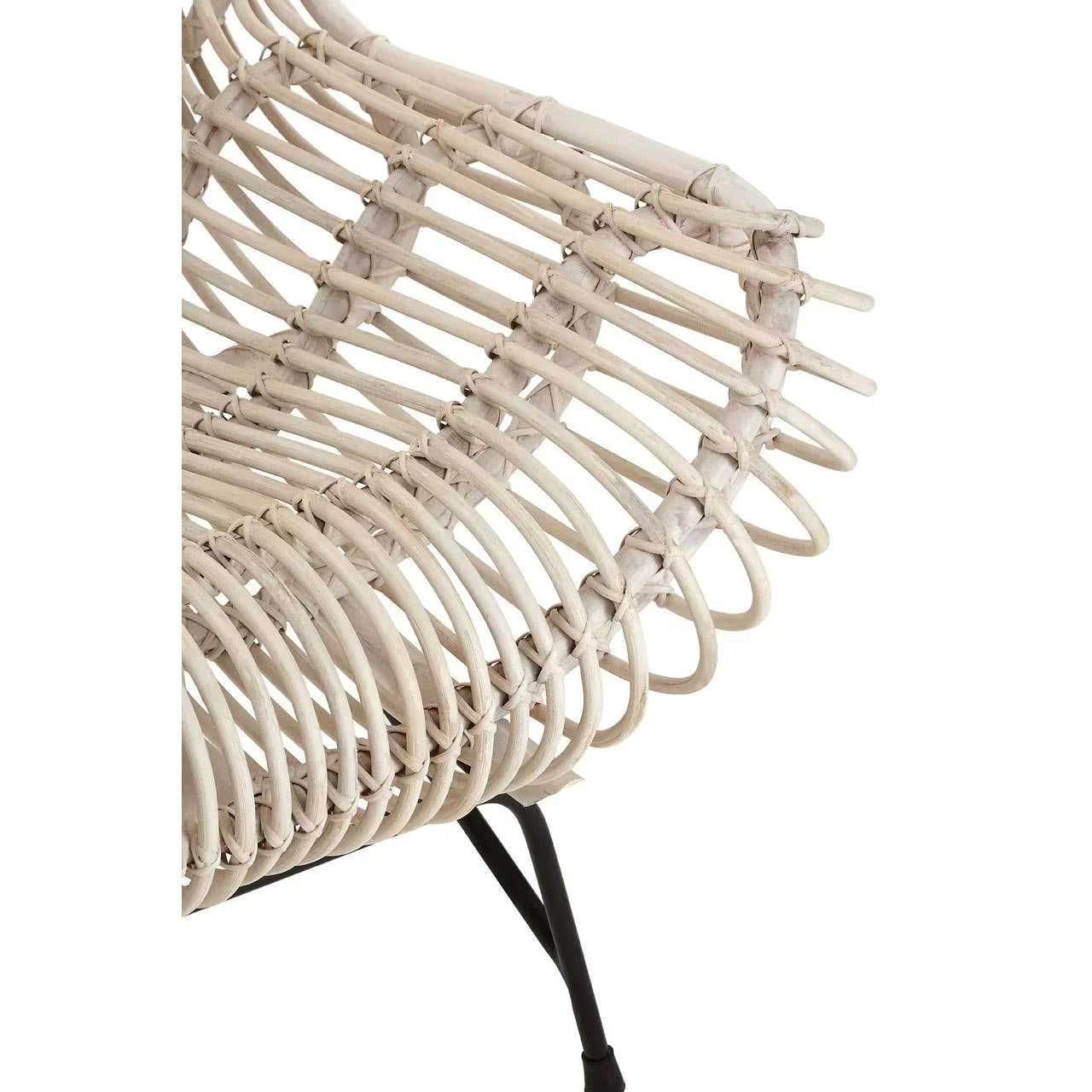 Close view of rattan chair armrest with woven seat and black metal leg