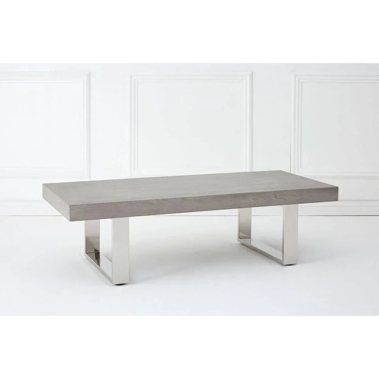Modern coffee table with grey wood top and chrome metal legs against white background