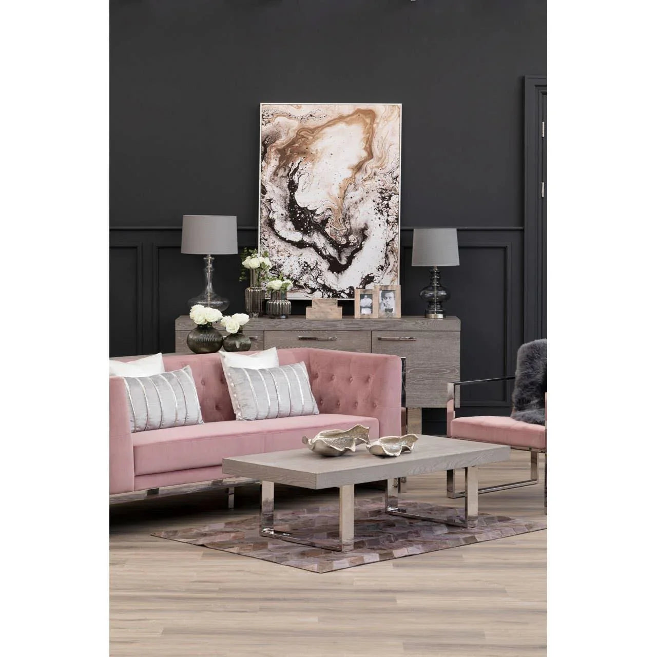 Blush pink velvet sofa and armchair set with grey coffee table in modern living room