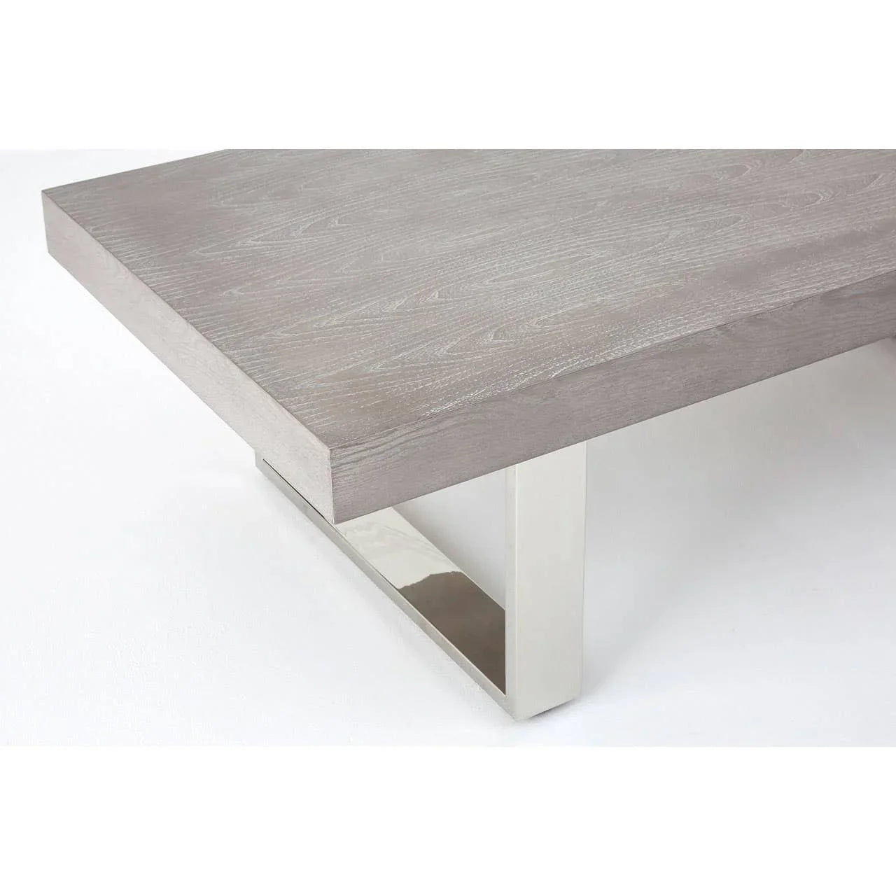 Grey wooden coffee table with sleek chrome legs, corner detail on white background