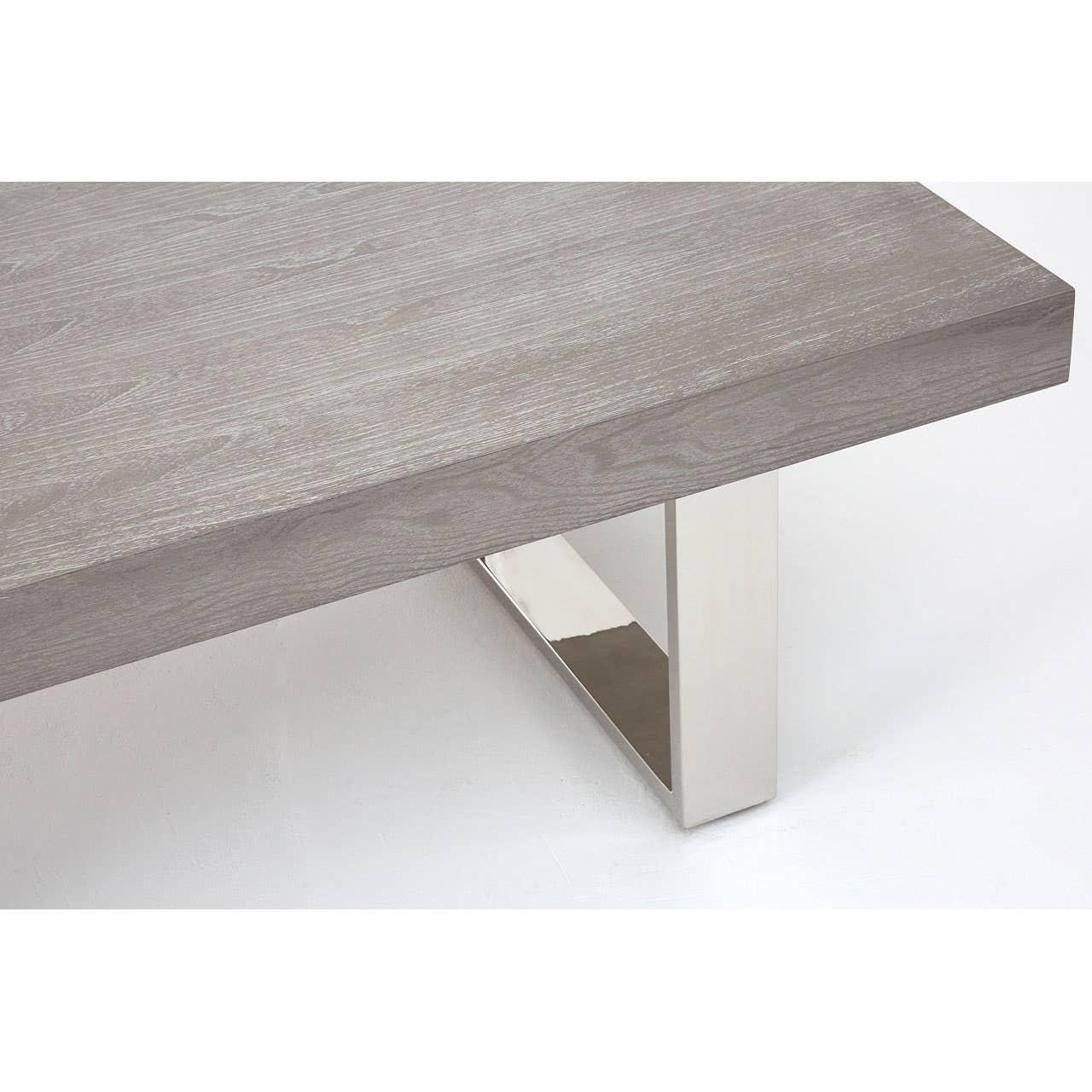 Grey wood coffee table with chrome metal leg, close-up of corner and base