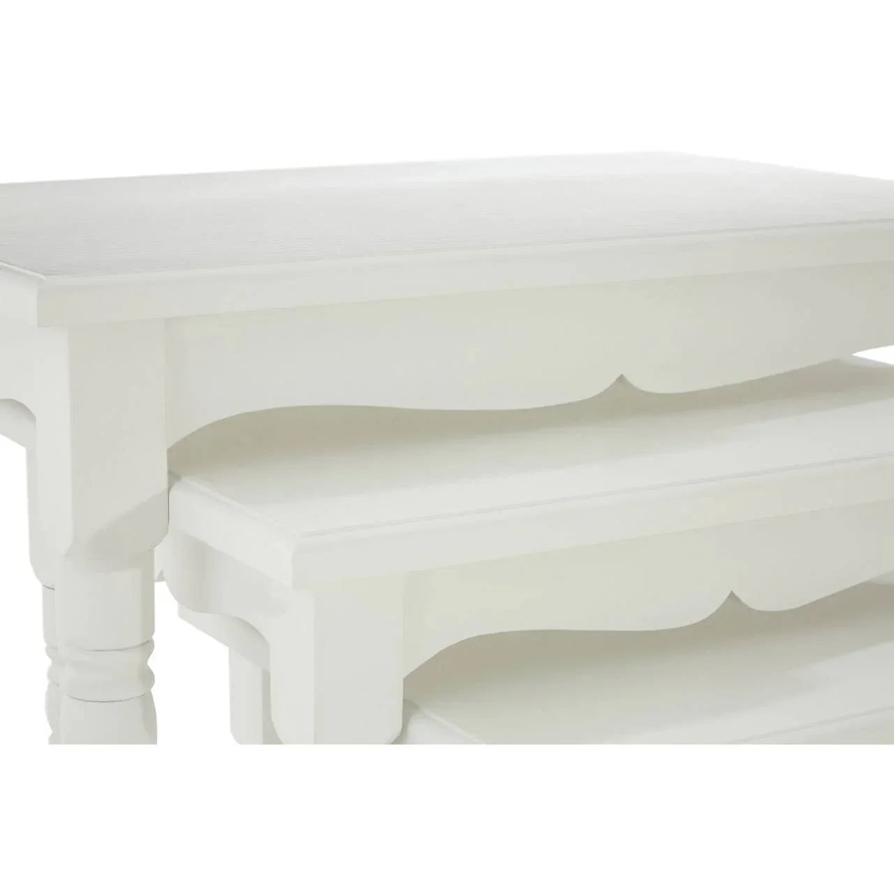 White wooden nesting tables with smooth finish and carved skirt detail