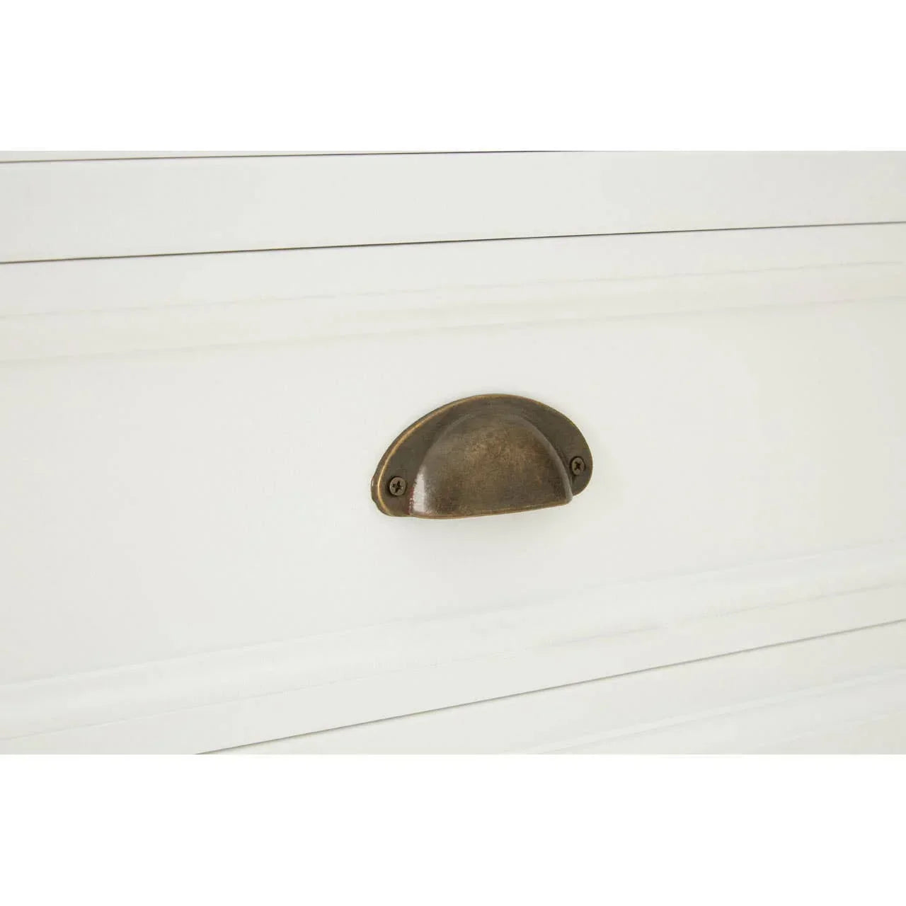 White drawer with antique brass cup handle in close-up view