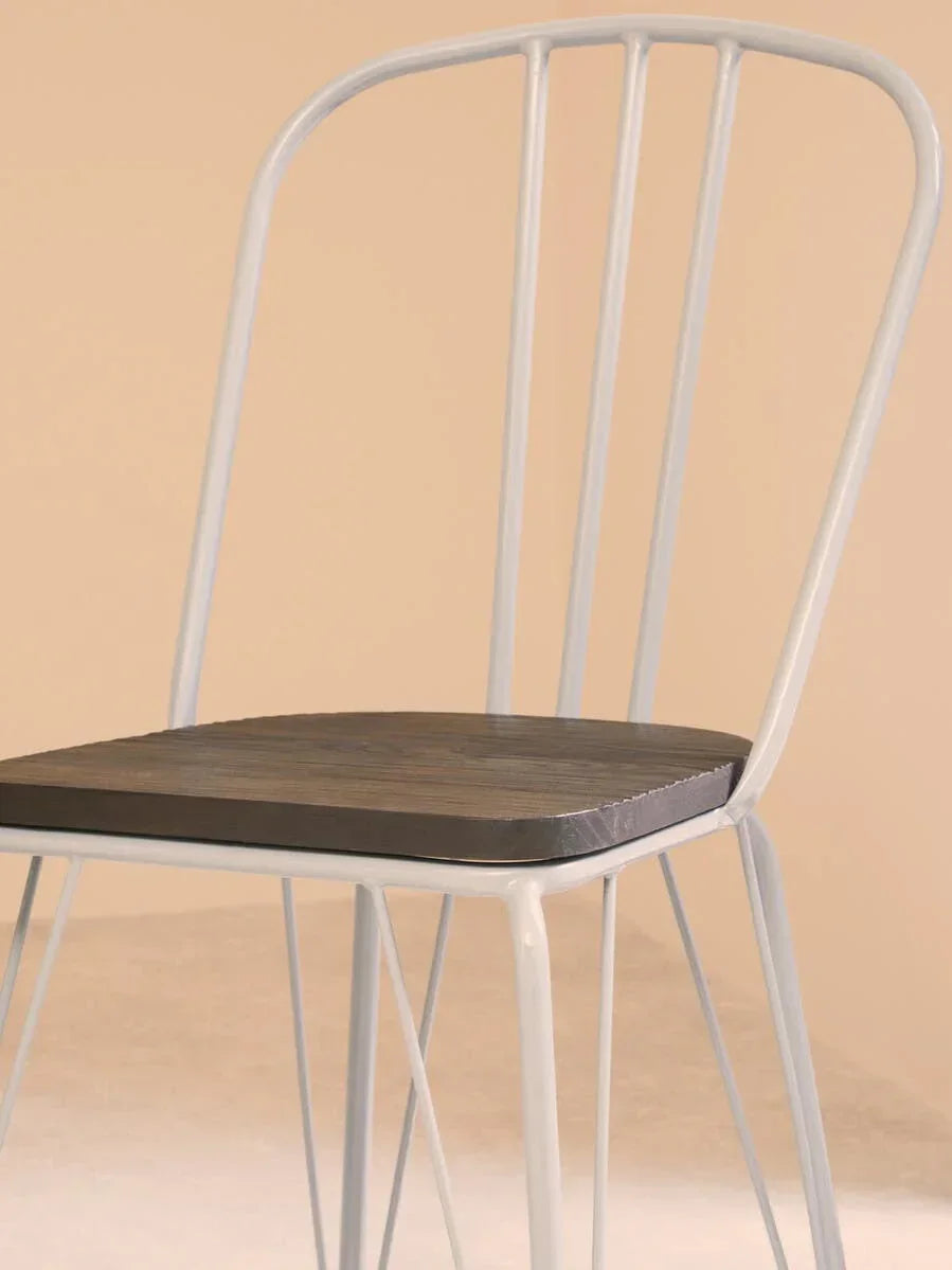 Metal dining chair with black wooden seat and light grey frame, close side angle