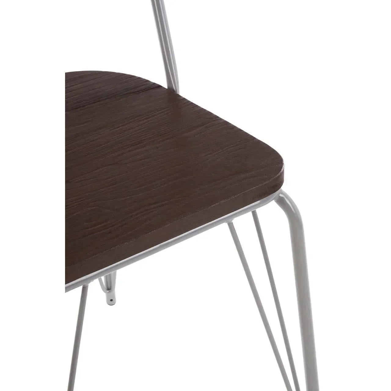 Closeup of dining chair with dark wood seat and white metal legs