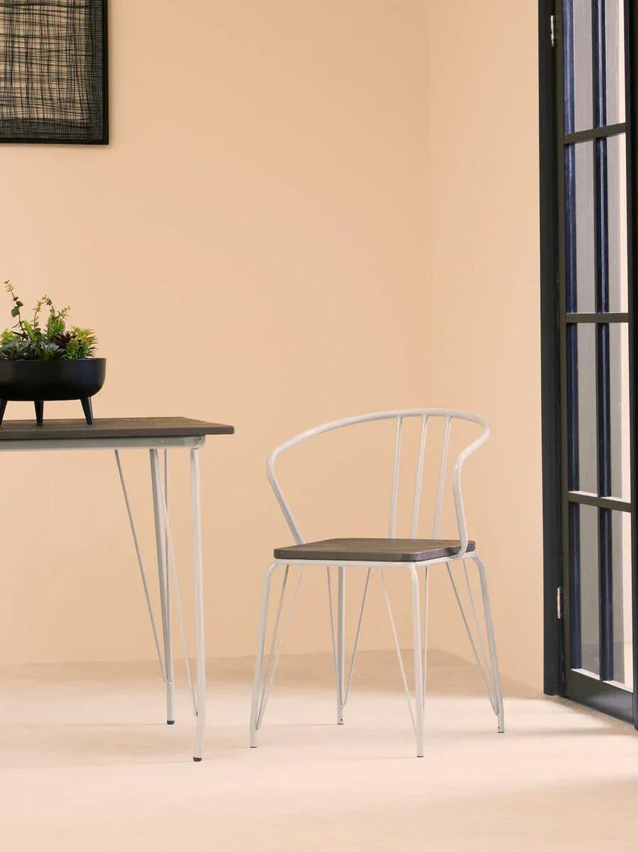 Modern dining chair with metal frame and wooden seat beside matching dining table