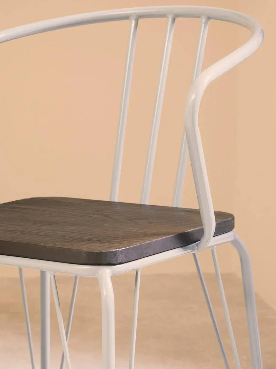 White metal dining chair with curved backrest and dark wood seat, side view