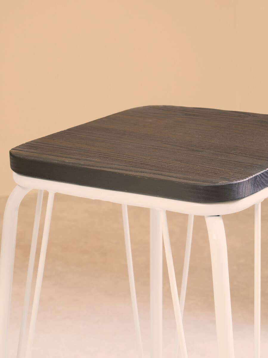 Square stool featuring a dark elm wood seat and white metal legs, set against a soft beige background. The design is minimalist and modern, highlighting the contrast between the wood and metal materials