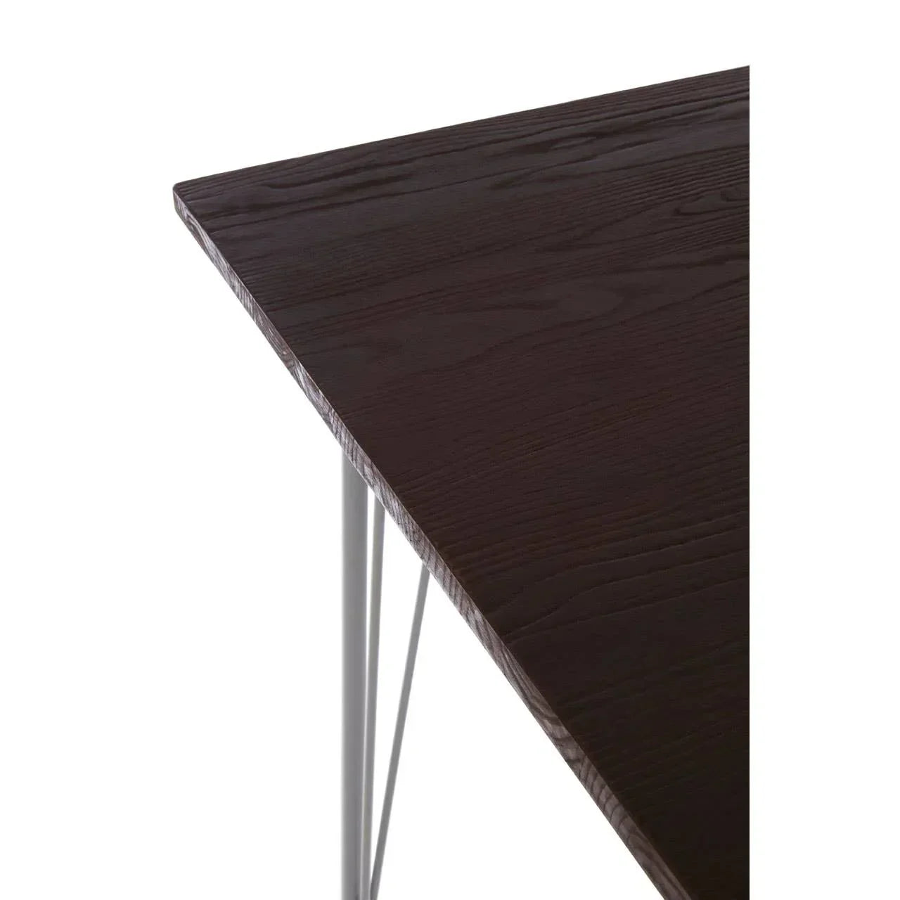 Dark wood dining table corner with visible grain and slim metal legs