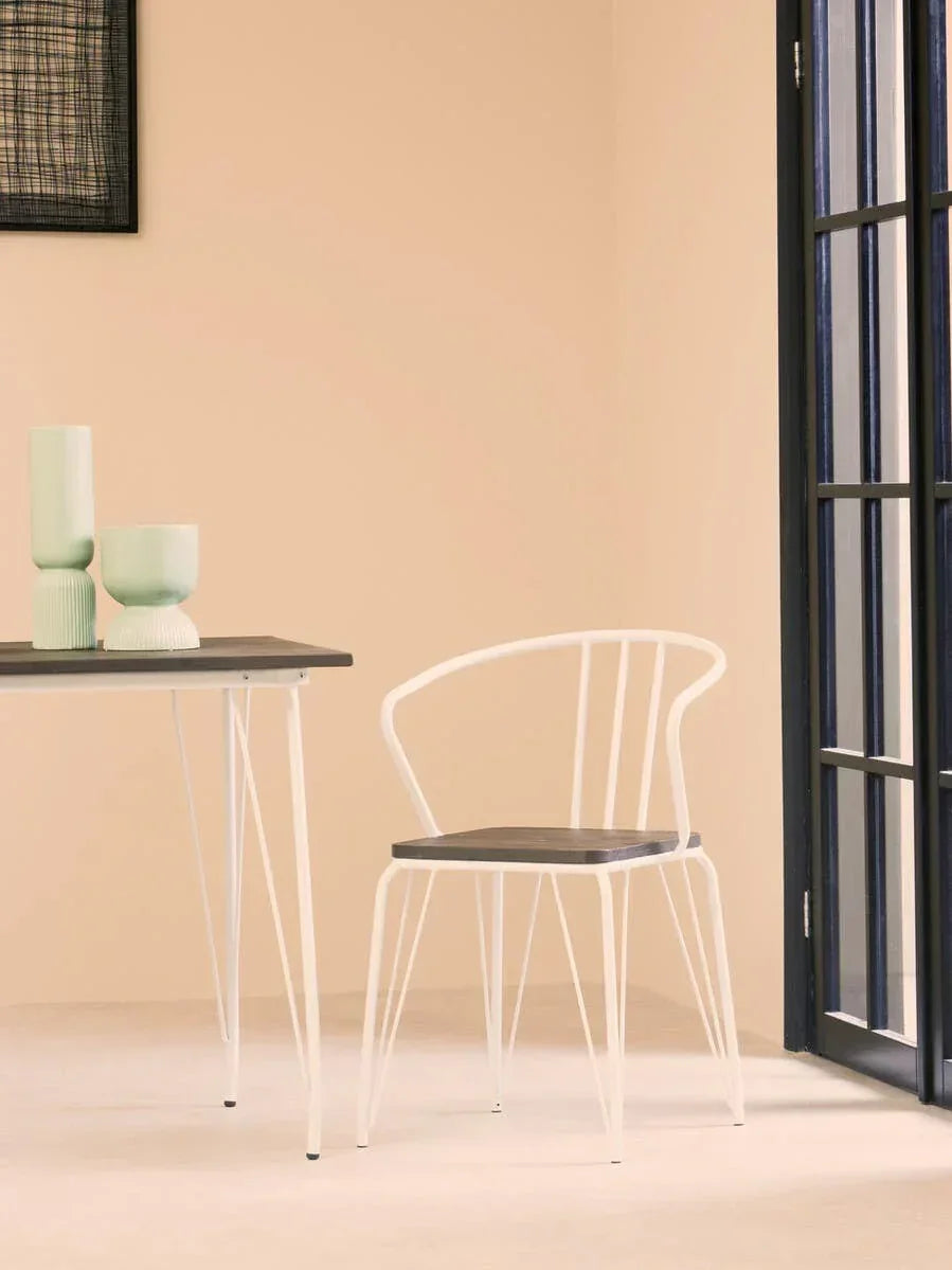 Modern dining chair with white metal frame and wood seat beside matching table