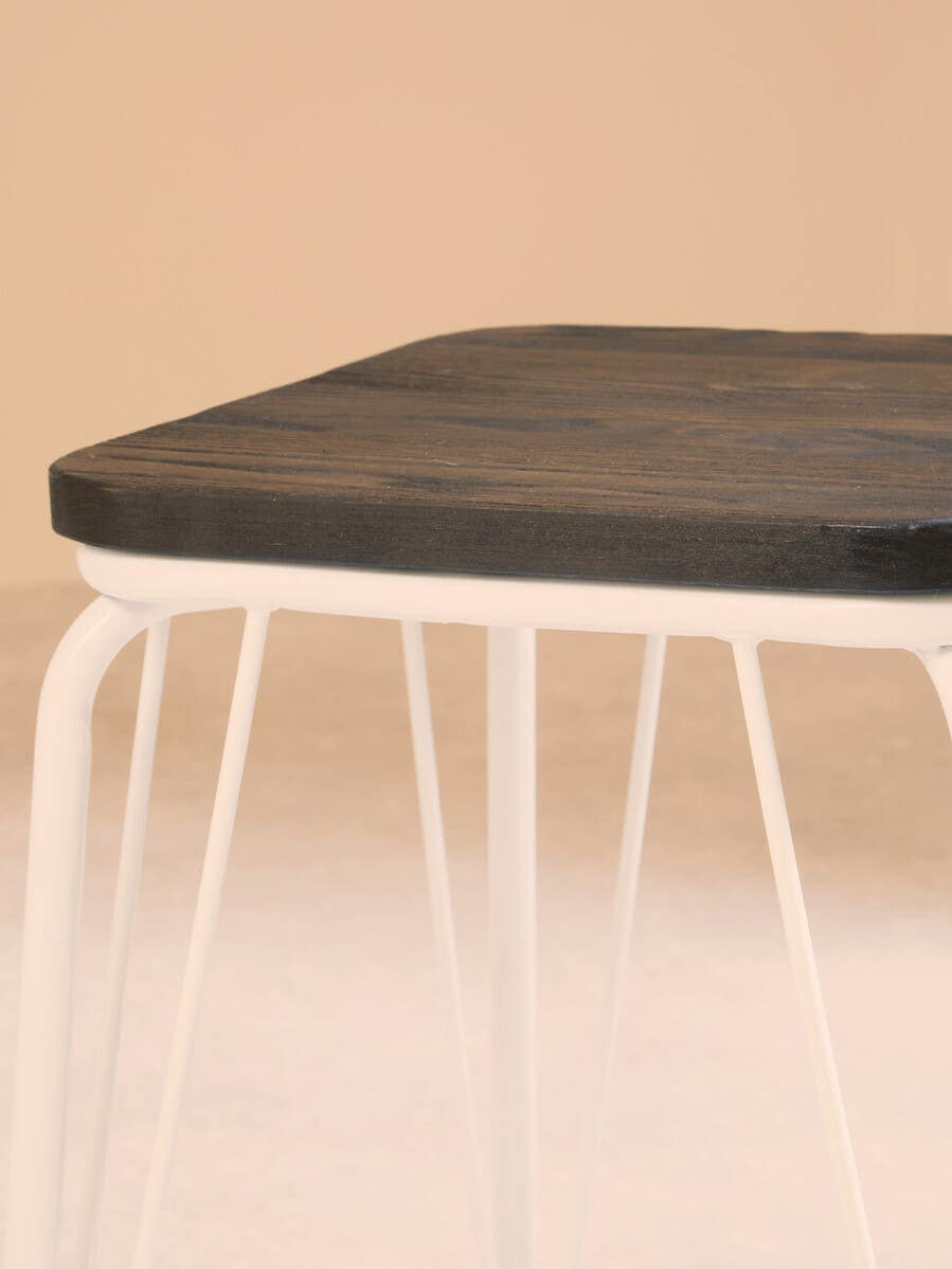 Small stool featuring a rectangular black elm wood top supported by sleek white metal legs, set against a soft, neutral background