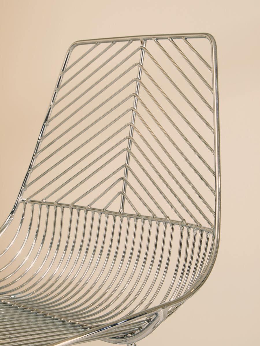 Chrome wire dining chair with chevron pattern backrest and curved seat detail