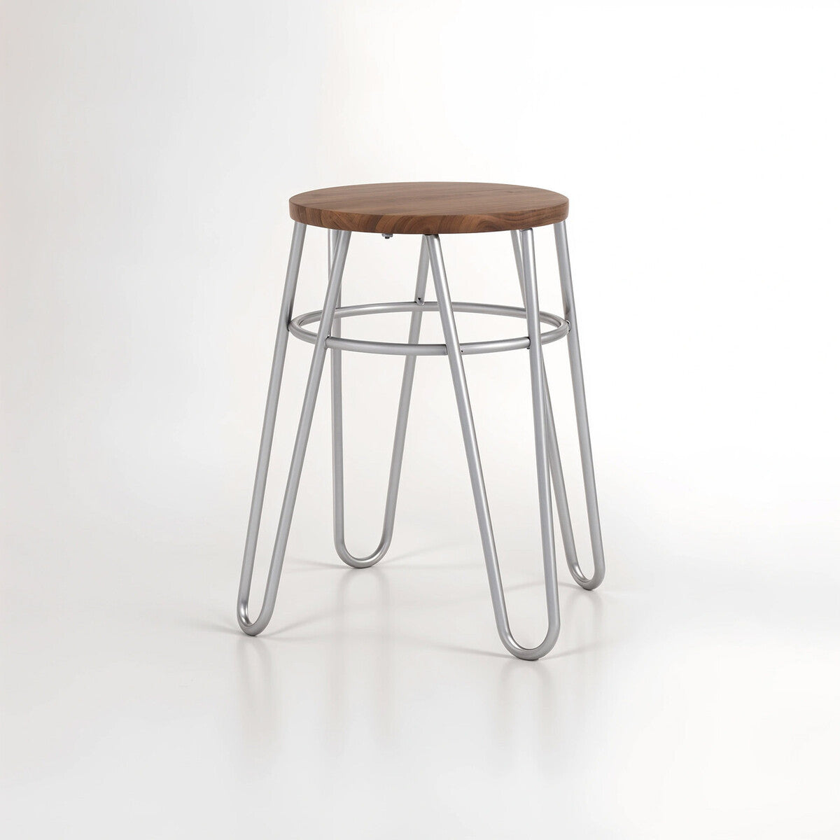 A grey metal hairpin stool with a round wooden seat and four slender, angled legs, set against a plain white background