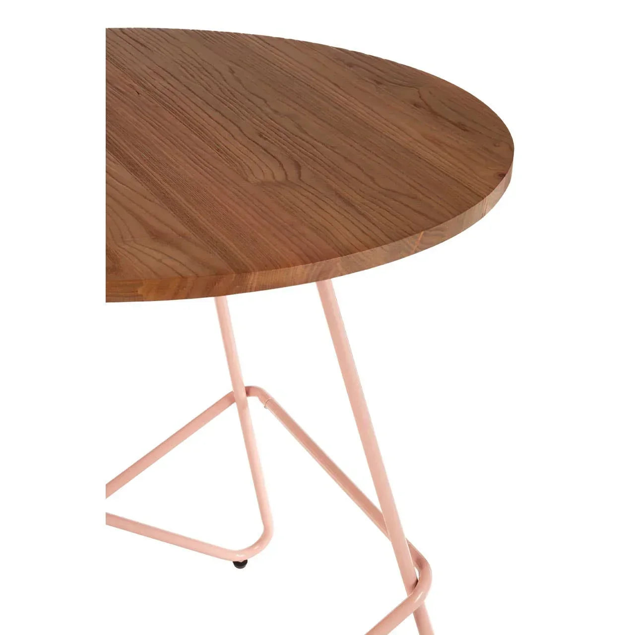 Round wooden dining table with pink metal legs, close-up on tabletop and frame