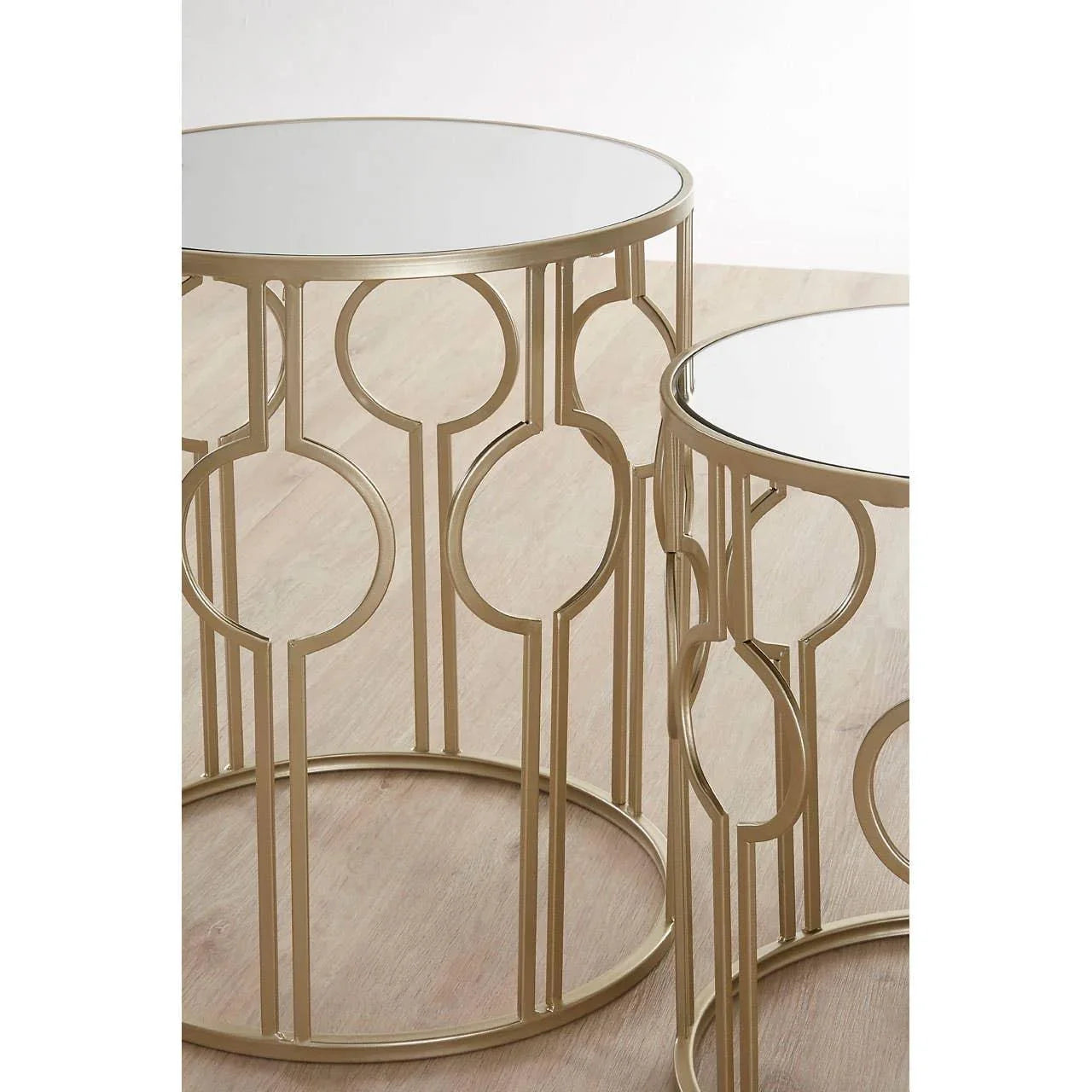 Round mirrored side tables with gold metal frames and geometric circular pattern bases